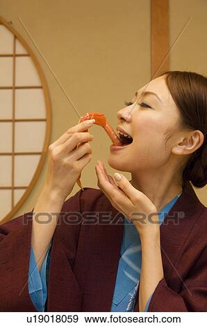 Stock Photo - Woman in yukatas eating seafood. Fotosearch