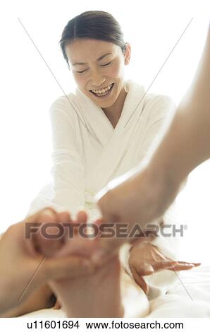 Woman laughs while receiving a foot massage View Large Photo Image Picture - Woman laughs while receiving a foot massage. Fotosearch