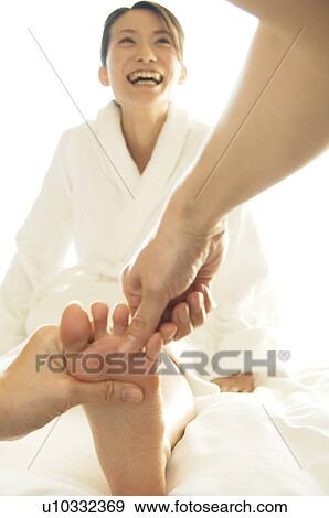 Woman laughs while receiving a foot massage View Large Photo Image Stock Photo - Woman laughs while receiving a foot massage. Fotosearch