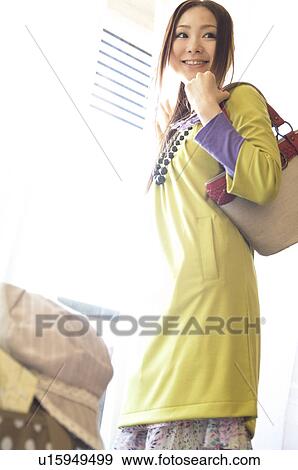 Woman looking out hotel room window View Large Photo Image Stock Photo - Woman looking out hotel room window. Fotosearch