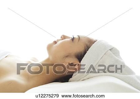 Stock Photo - Woman lying on her back before a massage. Fotosearch