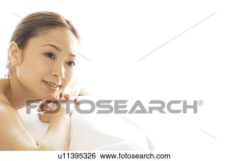Stock Photograph - Woman lying on her stomach. Fotosearch