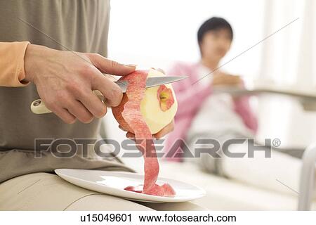 Woman peeling an apple for her boyfriend View Large Photo Image Stock Image - Woman peeling an apple for her boyfriend. Fotosearch