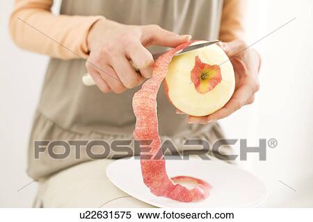 Stock Photography - Woman peeling an apple. Fotosearch