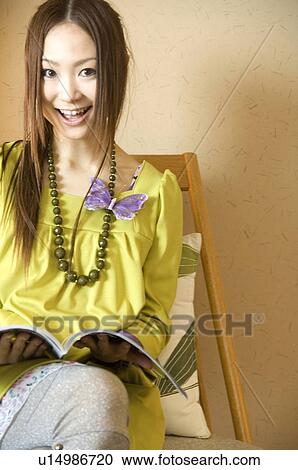 Stock Image - Woman reading a magazine. Fotosearch