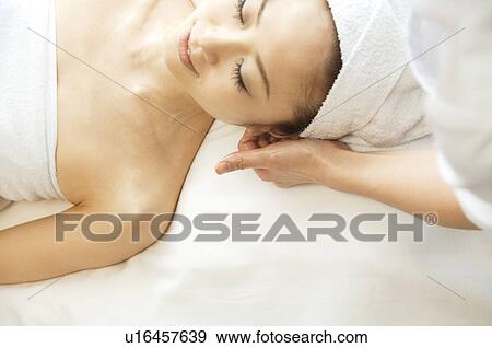 Stock Photo - Woman receiving a massage. Fotosearch