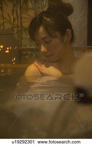 Woman relaxing in a hot tub View Large Photo Image Stock Image - Woman relaxing in a hot tub. Fotosearch