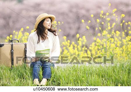 Woman sitting on roadside with suitcase and map View Large Photo Image Stock Photo - Woman sitting on roadside with suitcase and map. Fotosearch