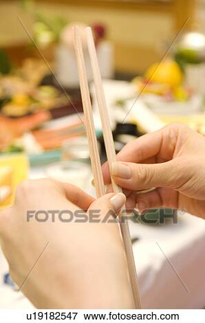 Stock Photo - Woman splitting chopsticks. Fotosearch