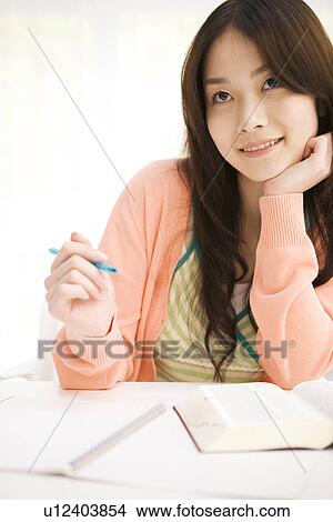 Woman studying at her desk View Large Photo Image Picture - Woman studying at her desk. Fotosearch