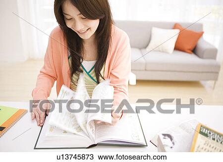 Stock Image - Woman studying at her desk. Fotosearch