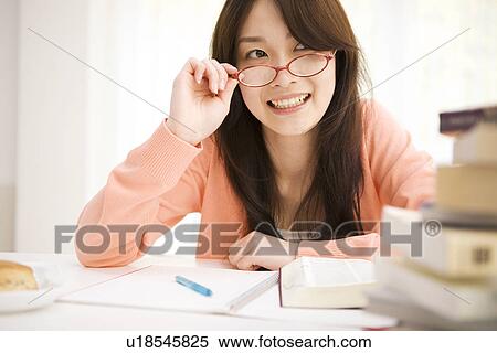 Woman studying at her desk View Large Photo Image Stock Photography - Woman studying at her desk. Fotosearch