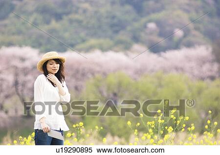 Woman walking wearing straw hat View Large Photo Image Stock Photography - Woman walking wearing straw hat. Fotosearch