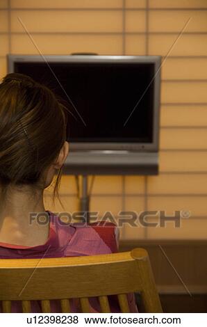 Stock Photo - Woman wearing yukata looking at blank TV screen. Fotosearch