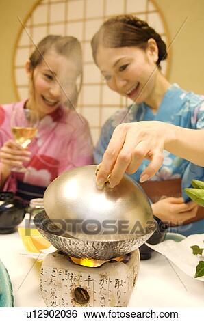 Women dressed in yukatas sitting down to eat a meal View Large Photo Image Stock Photograph - Women dressed in yukatas sitting down to eat a meal. Fotosearch
