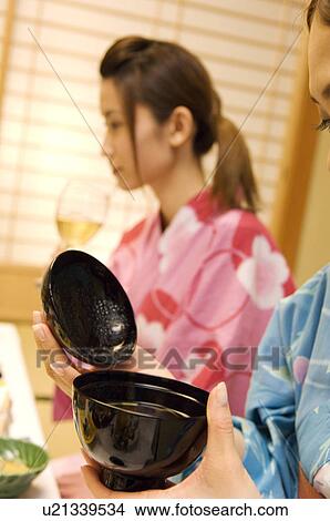 Women drinking wine and miso soup View Large Photo Image Picture - Women drinking wine and miso soup. Fotosearch