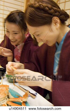 Stock Image - Women in yukatas eating seafood. Fotosearch