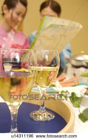 Women sitting at table with meal, reading map View Large Photo Image Stock Photograph - Women sitting at table with meal, reading map. Fotosearch