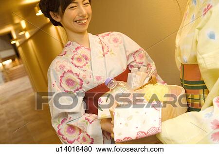 Women wearing yukata holding health spa products in a bamboo bucket View Large Photo Image Stock Image - Women wearing yukata holding health spa products in a bamboo bucket. Fotosearch