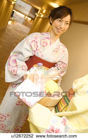 Women wearing yukata standing talking in hallway of health spa View Large Photo Image Stock Image - Women wearing yukata standing talking in hallway of health spa. Fotosearch