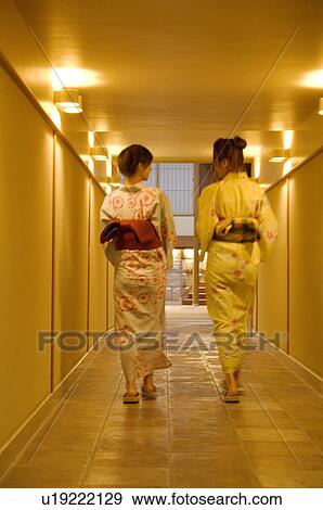 Women wearing yukata walking down a hallway of a health spa View Large Photo Image Stock Photo - Women wearing yukata walking down a hallway of a health spa. Fotosearch