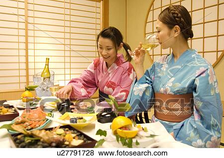 Women wearing yukatas sitting at table with seafood View Large Photo Image Stock Photo - Women wearing yukatas sitting at table with seafood. Fotosearch