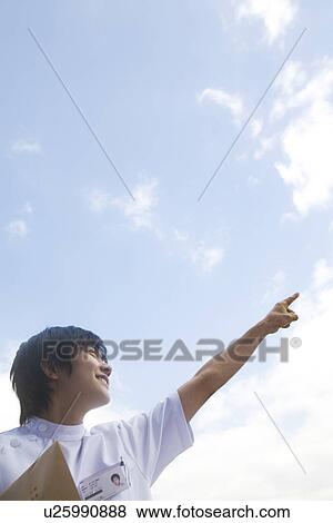 X-ray technician holding file and pointing upwards View Large Photo Image Stock Photo - X-ray technician holding file and pointing upwards. Fotosearch