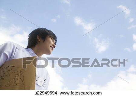 Picture - X-ray technician holding file. Fotosearch