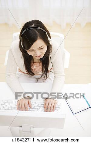 Young woman at computer working from home View Large Photo Image Stock Image - Young woman at computer working from home. Fotosearch