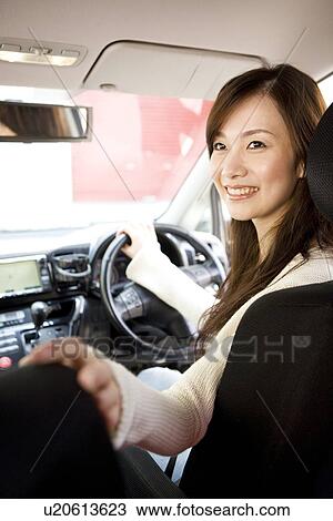Young woman driving car View Large Photo Image Stock Image - Young woman driving car. Fotosearch