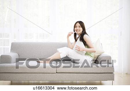 Young woman sitting brushing teeth View Large Photo Image Picture - Young woman sitting brushing teeth. Fotosearch