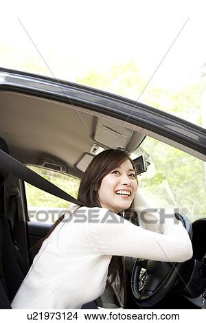 Young woman sitting in car View Large Photo Image Picture - Young woman sitting in car. Fotosearch