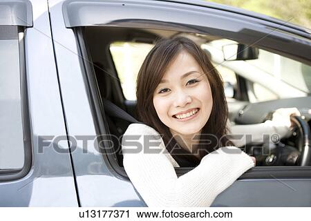 Young woman sitting in car View Large Photo Image Stock Image - Young woman sitting in car. Fotosearch