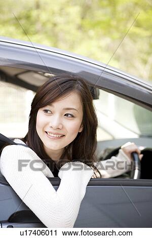 Young woman sitting in car View Large Photo Image Stock Image - Young woman sitting in car. Fotosearch