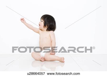 Stock Photo - 1 year old girl holding out hand. Fotosearch