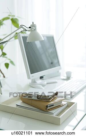 Stock Image - Address books on desk with computer. Fotosearch