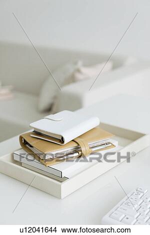 Address books stacked in living room View Large Photo Image Picture - Address books stacked in living room. Fotosearch