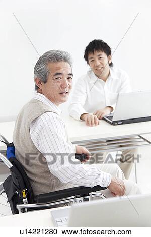 Stock Image - Adult students in a classroom. Fotosearch