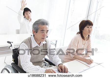 Stock Image - Adult students in a classroom. Fotosearch