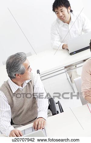 Stock Image - Adult students in a classroom. Fotosearch