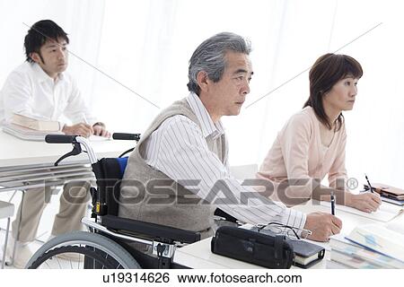 Stock Photograph - Adult students in a classroom. Fotosearch