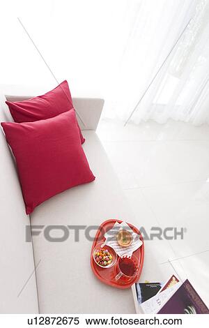 Stock Photography - Afternoon tea and books on a sofa. Fotosearch