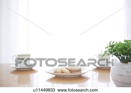 Afternoon tea and cookies on a living room table View Large Photo Image Stock Image - Afternoon tea and cookies on a living room table. Fotosearch
