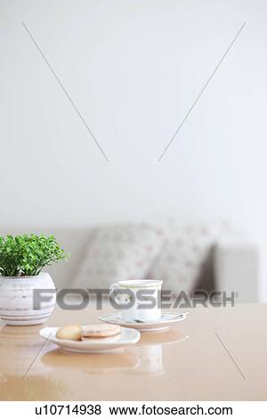 Stock Photo - Afternoon tea and cookies on a living room table. Fotosearch
