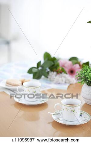 Stock Photo - Afternoon tea and cookies on a living room table. Fotosearch