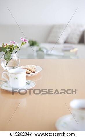 Stock Photo - Afternoon tea and cookies on a living room table. Fotosearch