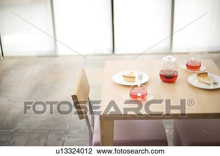Stock Image - Afternoon tea of cheesecake and herbal tea. Fotosearch