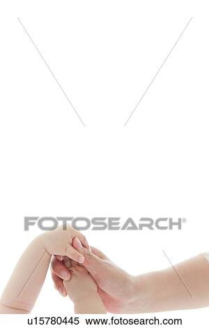 Stock Photography - Baby and parent holding hands. Fotosearch