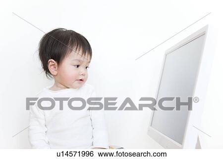 Baby boy looking at computer screen View Large Photo Image Stock Photograph - Baby boy looking at computer screen. Fotosearch