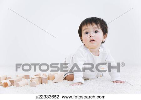 Baby boy next to blocks on a rug View Large Photo Image Stock Image - Baby boy next to blocks on a rug. Fotosearch